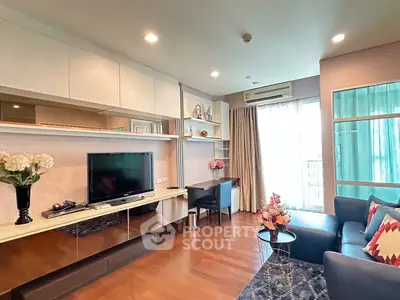 Modern living room with sleek design, featuring a cozy sofa, flat-screen TV, and elegant decor.