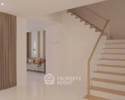 Elegant modern interior with staircase and cozy living area, featuring neutral tones and stylish decor.