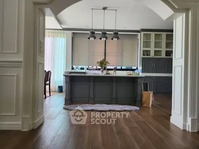 Spacious kitchen with island and modern cabinetry in elegant home.
