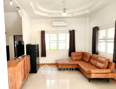 Spacious living room with modern leather sectional sofa and sleek entertainment unit.