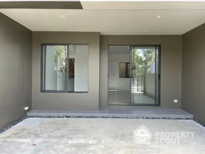 Modern home entrance with sleek design and large windows