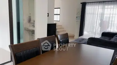 Modern open-plan living and dining area with sleek furniture and natural light.
