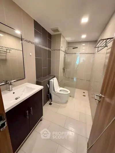 Modern bathroom with sleek fixtures and glass shower enclosure