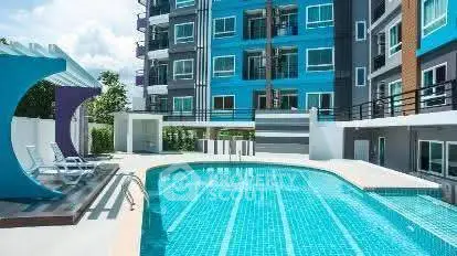 Modern apartment building with a stunning outdoor pool and lounge area.