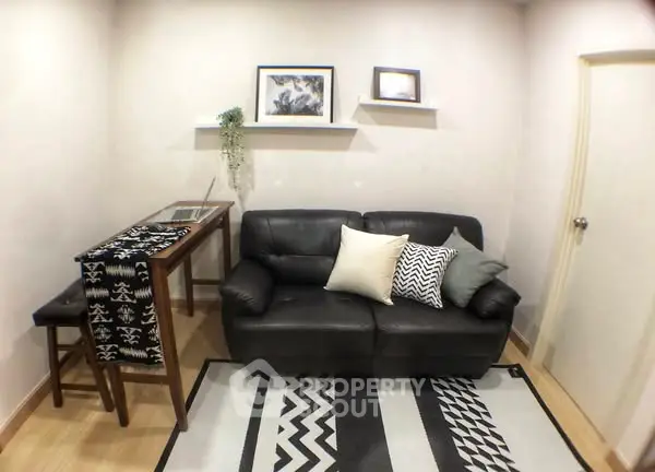 Cozy living room with stylish black leather sofa and modern decor