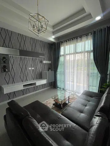 Modern living room with stylish decor and large windows for natural light.