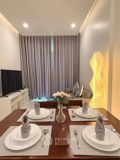 Modern living room with elegant dining setup and cozy seating area, perfect for entertaining guests.