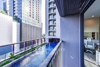 Modern urban apartment with balcony overlooking sleek pool and cityscape.