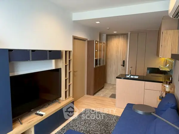 Modern living room with sleek kitchen and stylish decor