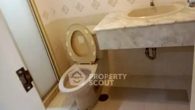 Compact bathroom with marble sink and shower in real estate property