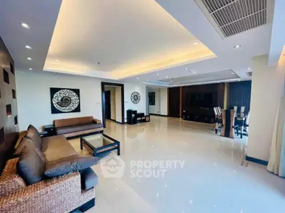 Spacious modern living room with elegant decor and ample natural light.