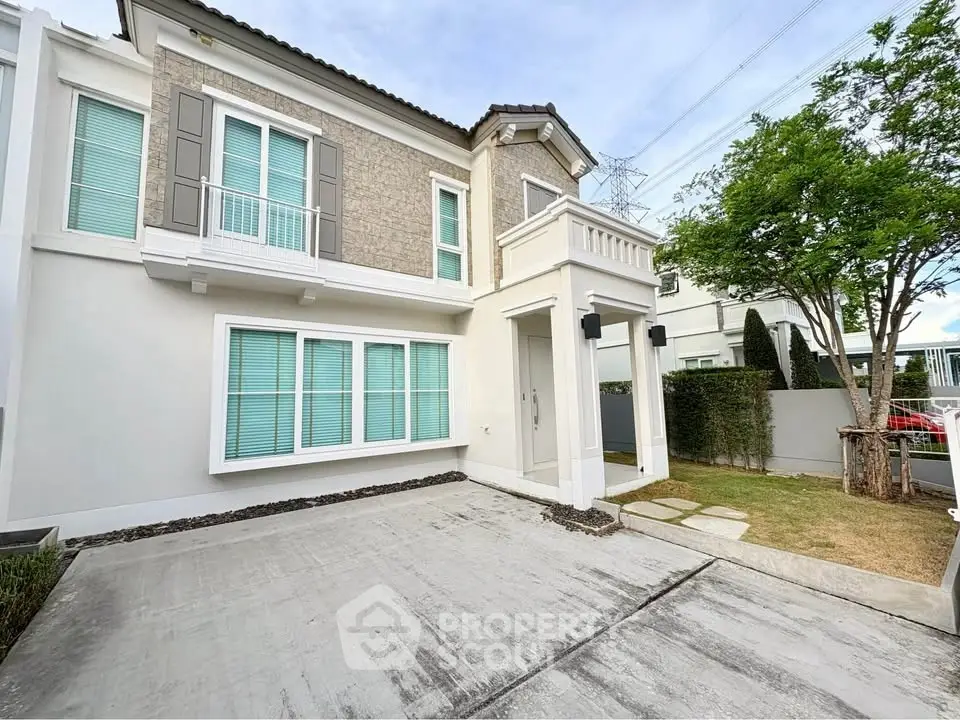 Modern two-story house with stylish facade and spacious driveway in a serene neighborhood.