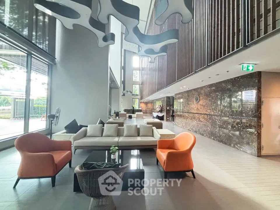 Luxurious modern lobby with stylish seating and artistic ceiling design
