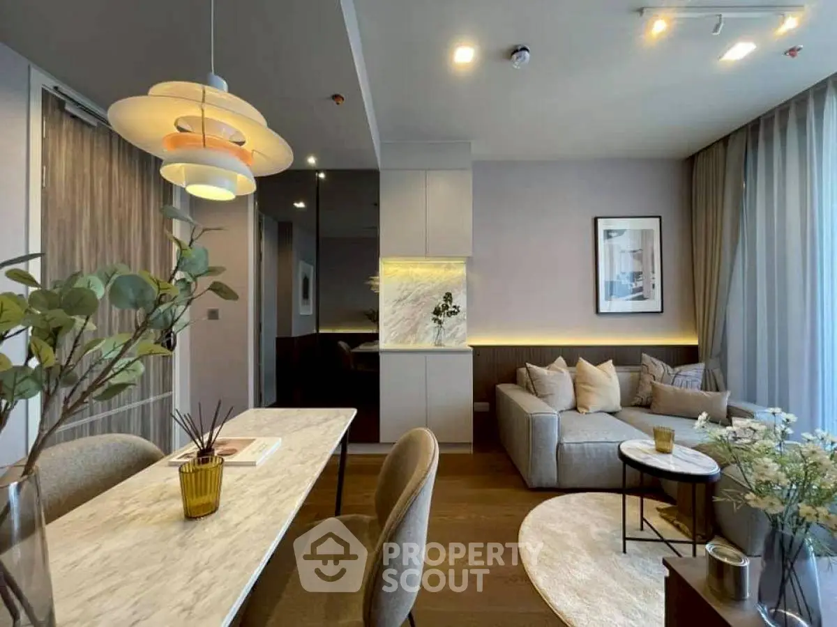 Modern living room with stylish decor, cozy seating, and elegant lighting in a contemporary apartment.