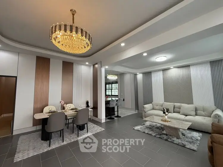 Luxurious modern living room with elegant chandelier and stylish decor