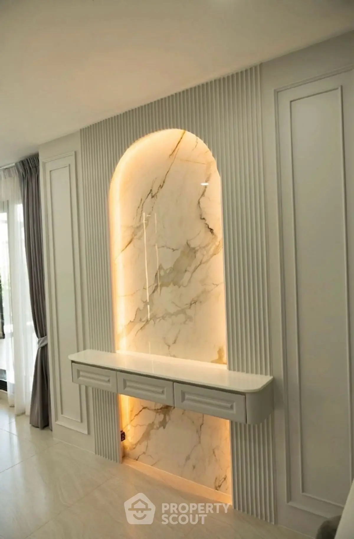 Luxurious interior design with marble accent wall and elegant lighting