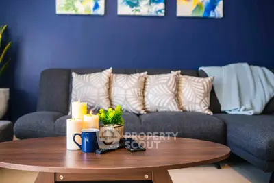 Stylish living room with modern decor, cozy sofa, and elegant coffee table setup.