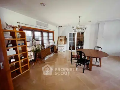 Spacious living room with elegant wooden flooring and stylish furniture, perfect for family gatherings.
