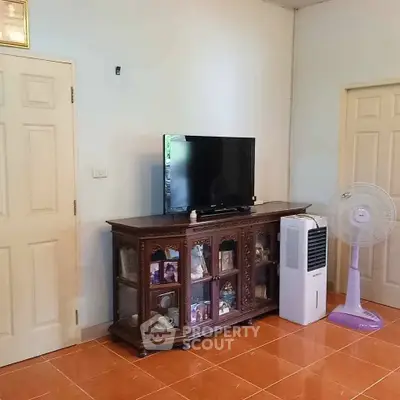 Cozy living room with classic wooden cabinet and modern TV setup