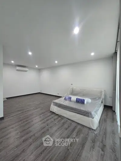 Spacious modern bedroom with sleek flooring and minimalist design