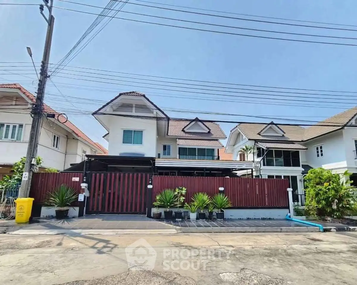 Charming suburban house with modern design and lush greenery in a peaceful neighborhood.