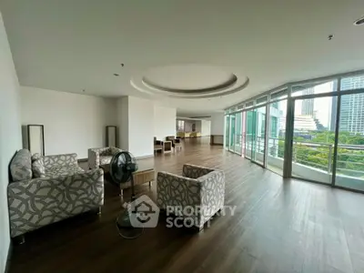 Spacious modern living room with large windows and city view