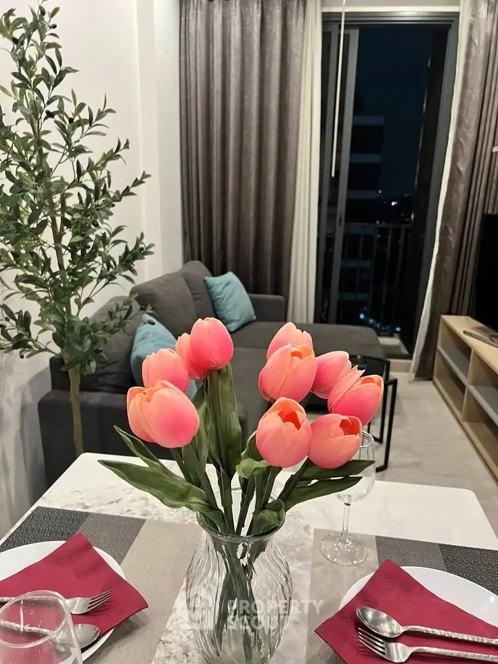 Chic modern living room with elegant dining setup and vibrant tulip centerpiece