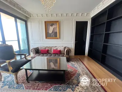 Elegant living room with classic decor, luxurious sofa, and ornate chandelier in a sophisticated apartment.