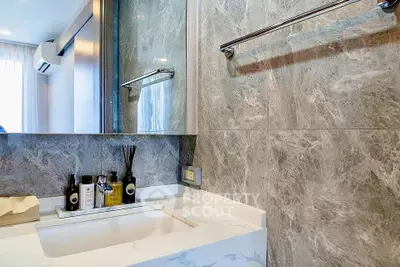 Modern bathroom with marble walls and sleek vanity in luxury apartment