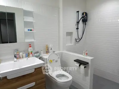 Modern bathroom with sleek white tiles and contemporary fixtures