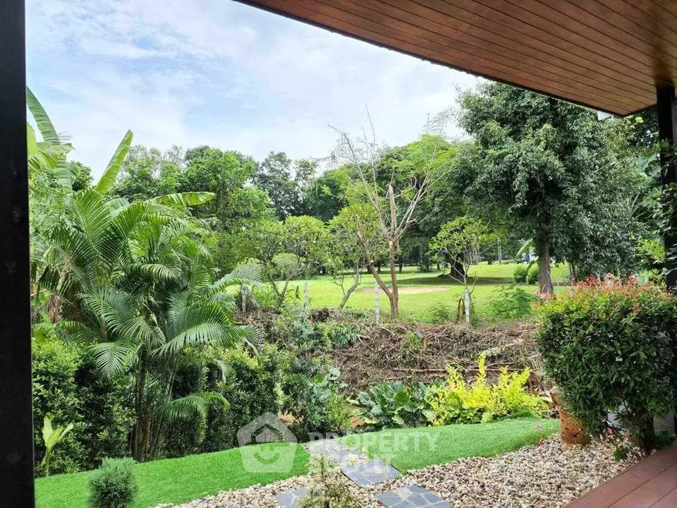Stunning garden view from a modern patio, surrounded by lush greenery and serene landscape.
