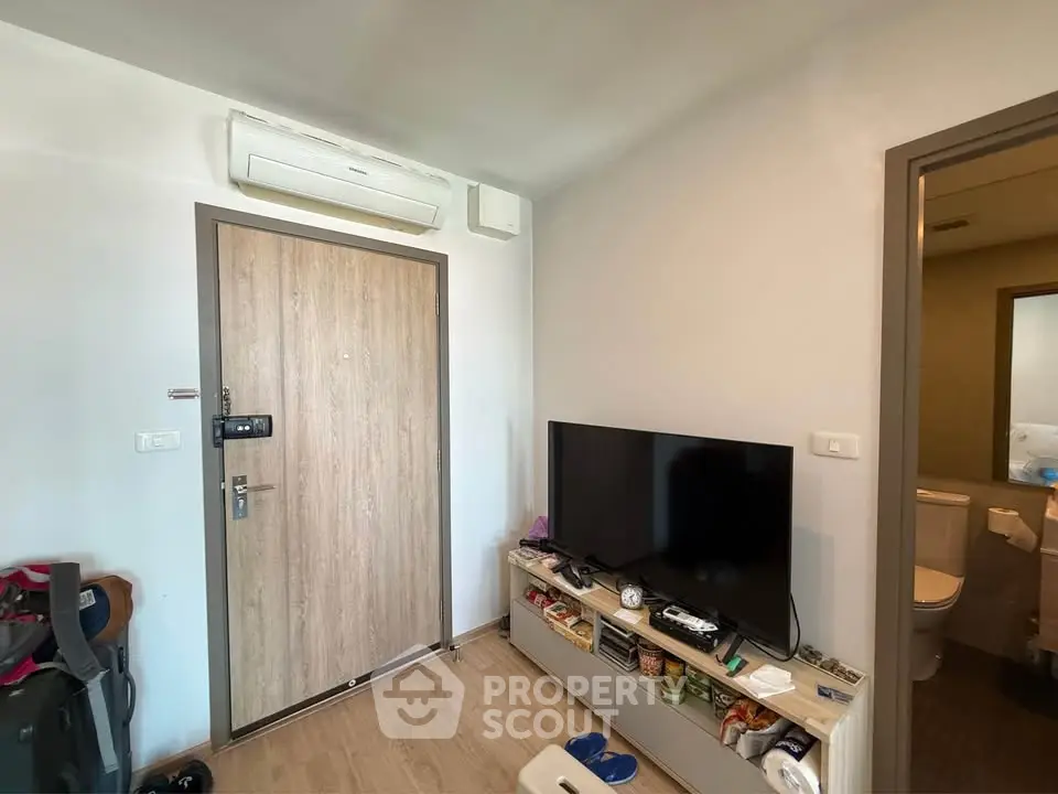Modern living room with TV and air conditioning in cozy apartment