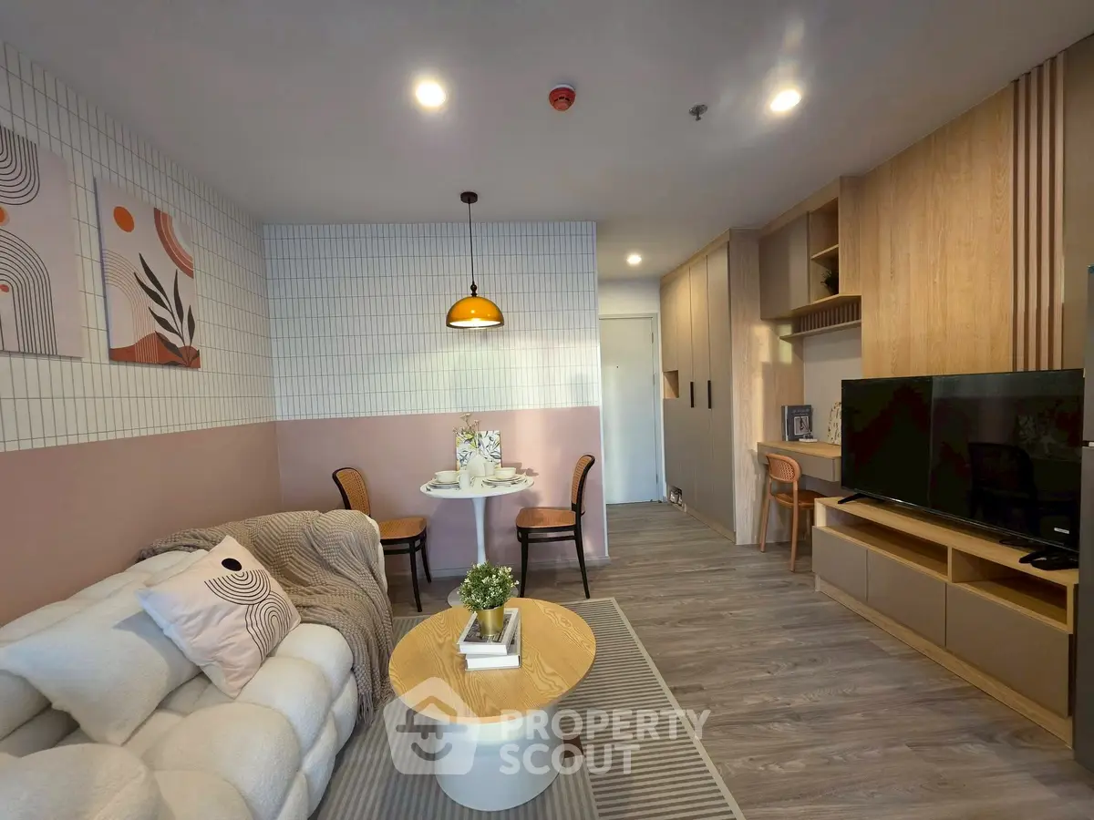 Stylish modern living room with cozy sofa, chic decor, and elegant dining area in open layout.