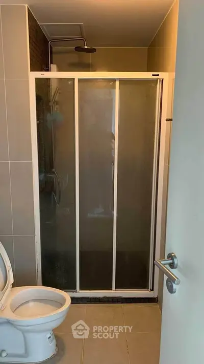 Compact bathroom with shower and toilet in modern apartment