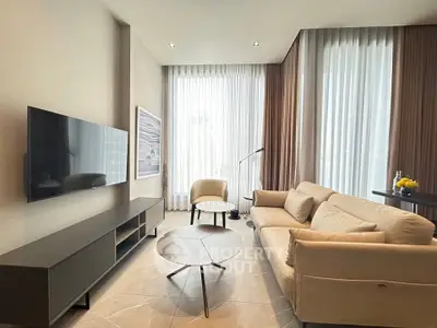 Modern living room with sleek furniture and large windows for natural light.