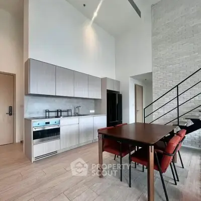 Modern kitchen with high ceiling and dining area in stylish apartment