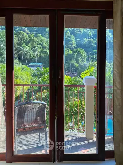 Stunning balcony view with lush greenery and pool, perfect for relaxation and enjoying nature.