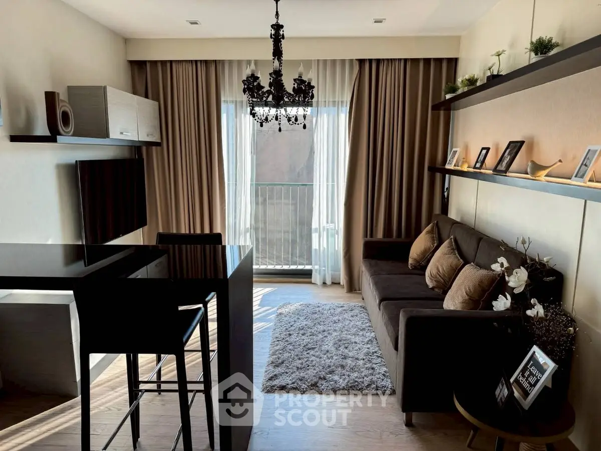 Stylish living room with elegant chandelier and cozy seating area, perfect for modern urban living.