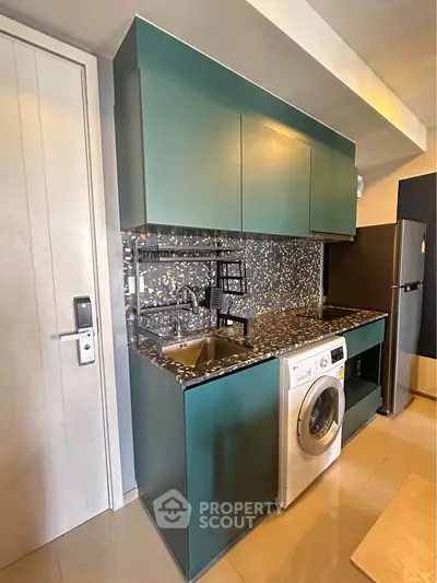 Modern kitchen with washing machine and sleek cabinetry