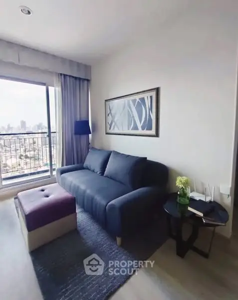 Modern living room with city view, stylish sofa, and chic decor