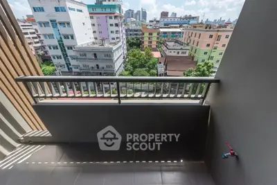 Spacious balcony with cityscape view, perfect for relaxation and enjoying urban living.