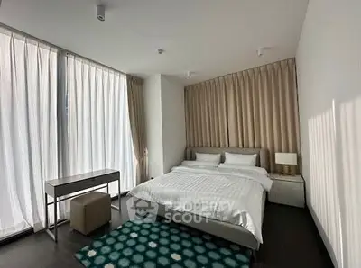 Spacious modern bedroom with large windows and elegant decor