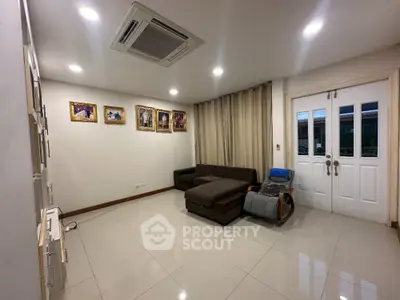 Spacious living room with modern decor and elegant lighting