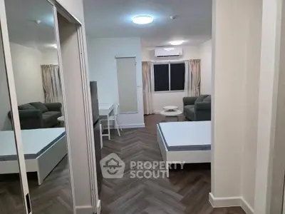 Modern studio apartment with sleek design, featuring mirrored closet doors and stylish flooring.
