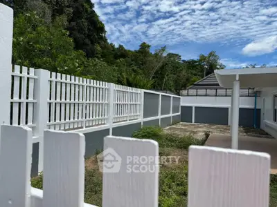 Spacious backyard with lush greenery and modern fencing, perfect for outdoor relaxation and activities.