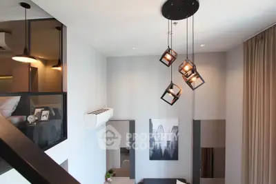 Modern loft-style living room with unique pendant lighting and stylish decor.