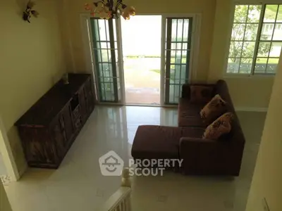 Spacious living room with elegant sofa and large windows for natural light