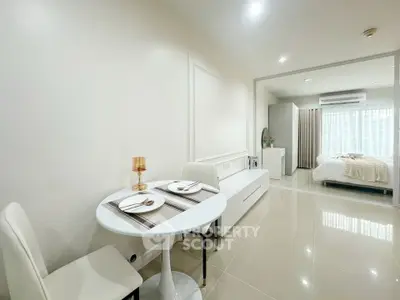 Modern open-plan living and dining area with elegant decor and natural light