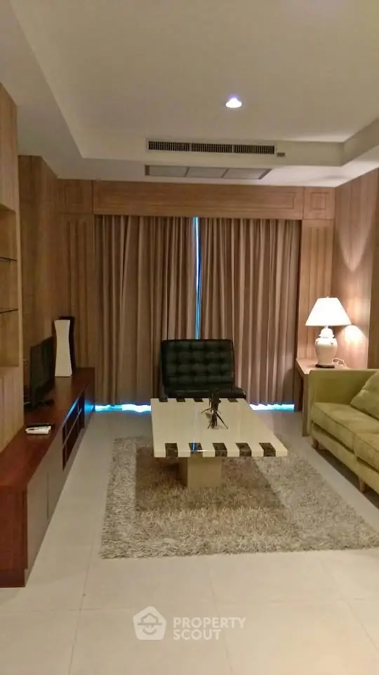 Elegant living room with modern furniture and ambient lighting, perfect for relaxation and entertainment.