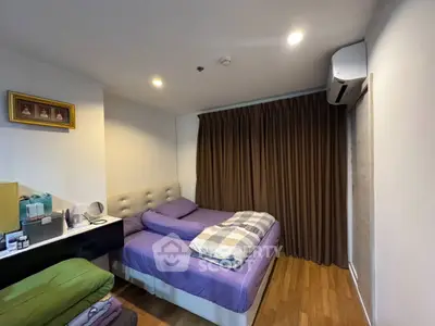 Cozy bedroom with modern decor and air conditioning, perfect for relaxation.